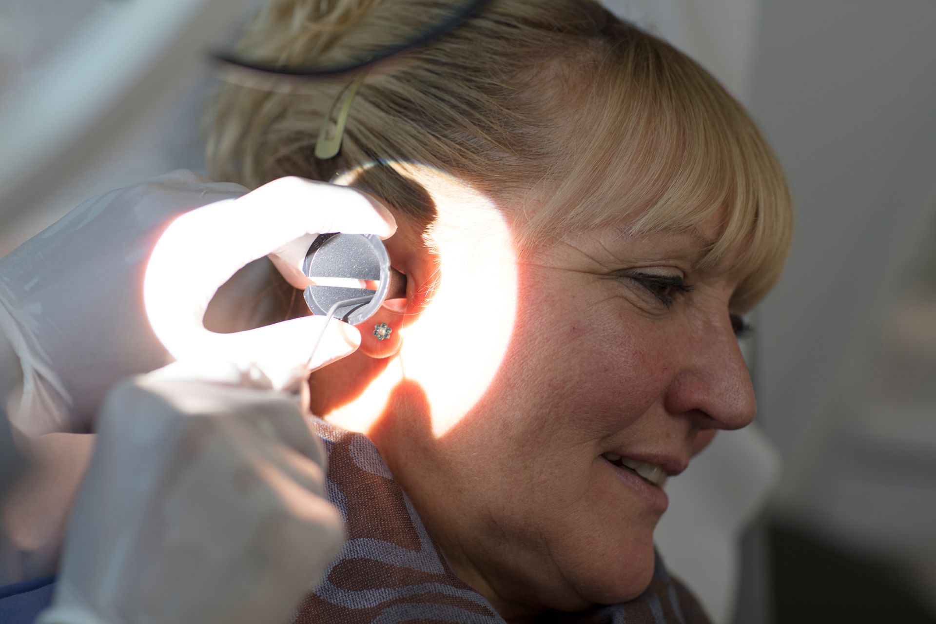Audiologist performing microsuction at Bridgend clinic