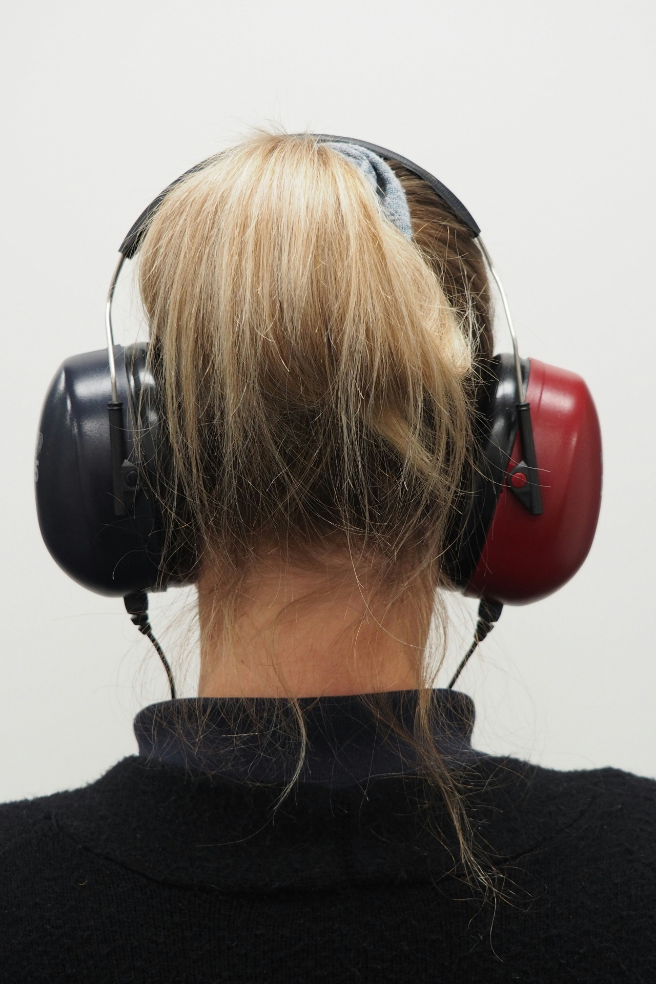 Patient wearing audiometric headphones inside the soundproof booth at Bridgend clinic